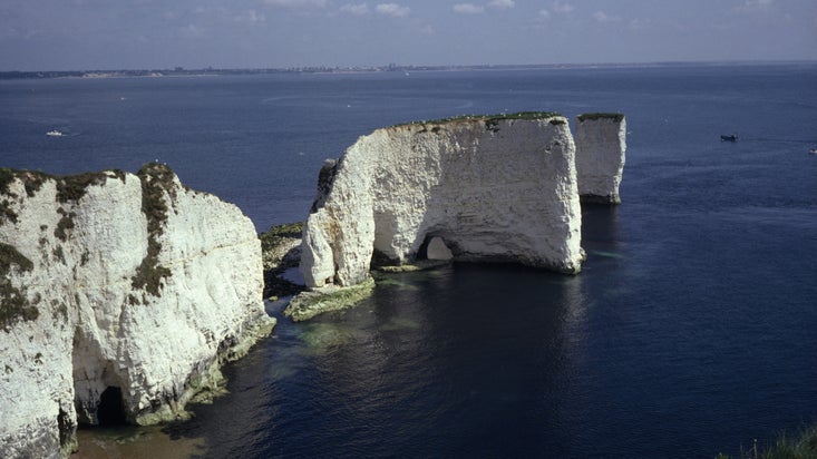 View of white chalk cliffs, arches and stacks of Old Harry Rocks near Studland, Dorset